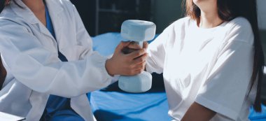 Tanımlanamayan fiziksel terapi sırasında mavi el ağırlığı kullanır