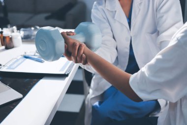 Tanımlanamayan fiziksel terapi sırasında mavi el ağırlığı kullanır