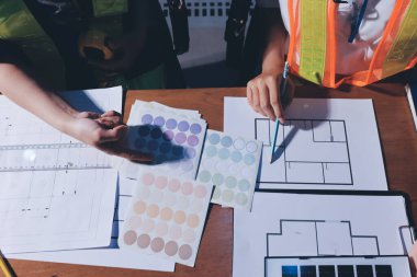 Endüstriyel mühendislerden oluşan bir ekip, fabrikadaki masada bulunan makine planlarını analiz ediyor. Fabrikada ya da üretim tesisinde çalışıyorum..