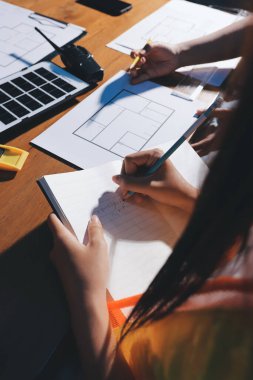 Endüstriyel mühendislerden oluşan bir ekip, fabrikadaki masada bulunan makine planlarını analiz ediyor. Fabrikada ya da üretim tesisinde çalışıyorum..