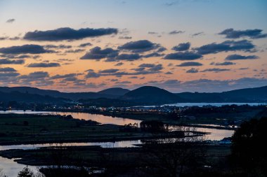 Dusk Over a Tranquil River Valley clipart