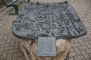 Ayrıntılı bronz yardım haritası tarihi Kappeln yerleşimini gösteriyor binalar, sokaklar ve bir yel değirmeni. Rahatlamanın dokusu ve derinliği Kappeln 'deki mimari detayları vurguluyor.