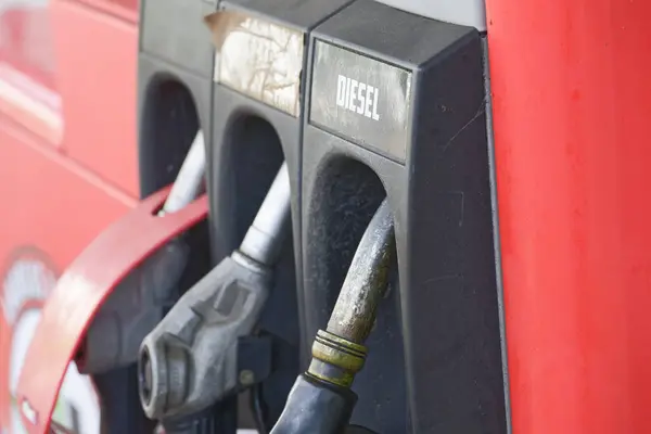 Eski bir benzin istasyonunda mazot ve mazot için pompa başlıkları asılıdır.