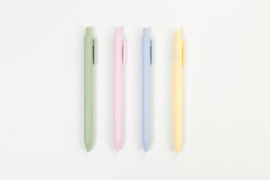 Beyaz arkaplanda renkli kalemlerin üst görünümü. Okul, ofis duvar kağıdı. Düz yat, boşluğu kopyala.