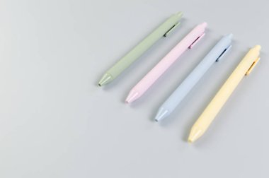 Gri arkaplanda renkli kalemlerin üst görünümü. Okul, ofis duvar kağıdı. Düz yat, boşluğu kopyala.