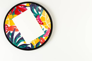 Siyah tepsinin üst görüntüsü, renkli plaka, beyaz arka planda beyaz kart. Egzotik bitki plakası, yaz pikniği. Düz yat, boşluğu kopyala.