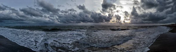Sun sleeping at horizon over sea and  night and bad weather will be come  in a rough sea and dark cloudy windy dramatic sky warn that dangerous will be travel