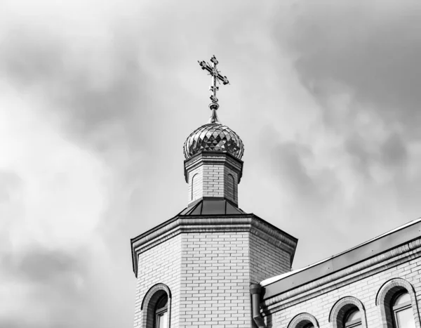 Christian church cross in high steeple tower for prayer, photography consisting of beautiful church with cross on steeple tower to sincere prayer, cross steeple tower is church prayer over clear sky