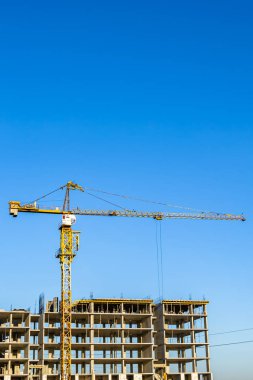 Konut binasının inşaat sahasındaki büyük çelik vinç, konut inşaatı alanındaki büyük vinçten oluşan fotoğraf, konut inşaatı alanındaki yüksek vinç.