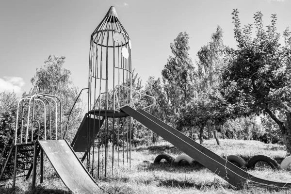 Photography on theme empty playground with metal slide for kids on background natural nature, photo consisting from playground with steel slide, slide on old playground in urban area without people