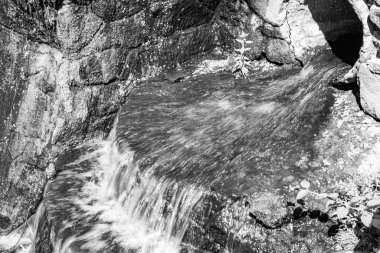 Tema üzerine fotoğraf. Bahçe şelalesinden güzel bir sonbahar suyu, doğal doku yakın, doğa bahçesi şelalesi ile berrak su içeren bir fotoğraf, uzun şelaleden hızla akan su.