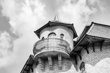 Temalı eski tuğladan bir şato. Arka planda büyük bir kulesi var. Büyük kulesi olan antik tuğladan bir şatonun fotoğrafı.