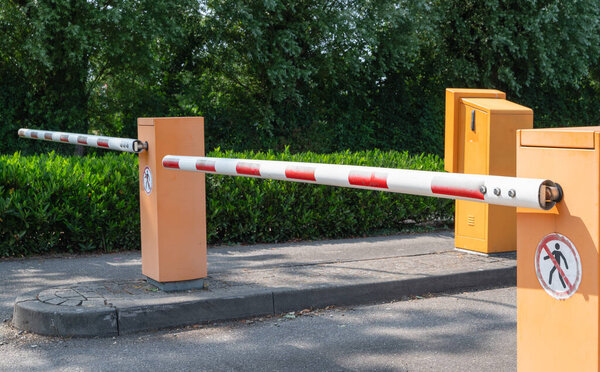 A modern barrier gate effectively sections off a parking lot for better management and enhanced security