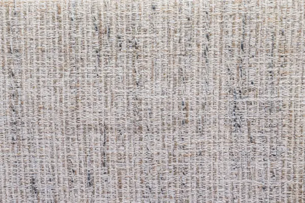 Doğal bej ve gri tonlarda görünen liflerle kabaca dokunmuş kumaş. Kırsal tekstil dokusu arka plan, ambalaj veya çevre dostu tasarım projeleri için mükemmeldir.. 