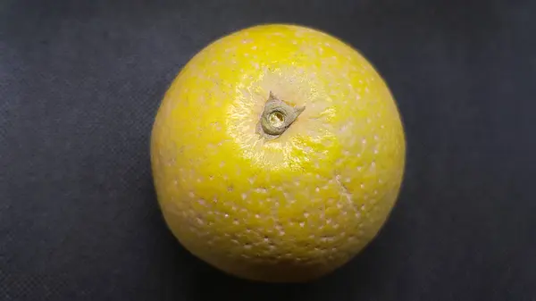 a close up image of a yellow and green lemon