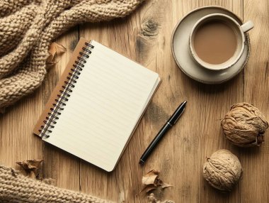 Kahve, defter ve kalemle samimi bir sahne.