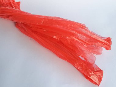 Şeffaf kırmızı kırışık beyaz arka planı olan plastik poşet.