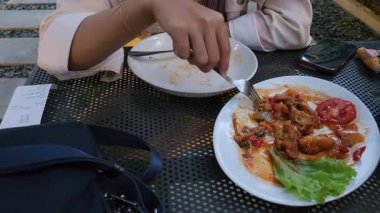 Yemeğini bitiren genç bir kadın.