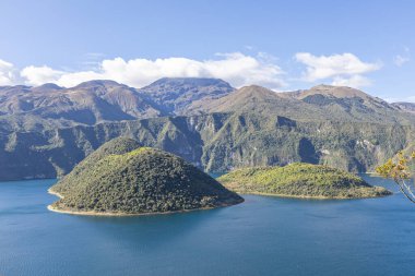 Cotacachi, Ecuador  August 5, 2025: Cuicocha Lagoon in the Ecuadorian Andes, surrounded by vegetation. In the background, the majestic Cotacachi Volcano with its summit hidden among the clouds.