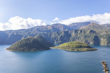 Cotacachi, Ecuador  August 5, 2025: Cuicocha Lagoon in the Ecuadorian Andes, surrounded by vegetation. In the background, the majestic Cotacachi Volcano with its summit hidden among the clouds.