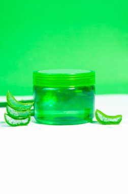 Aloe vera gel with fresh aloe slices, isolated on a clean white background. Perfect for natural skincare product presentations.