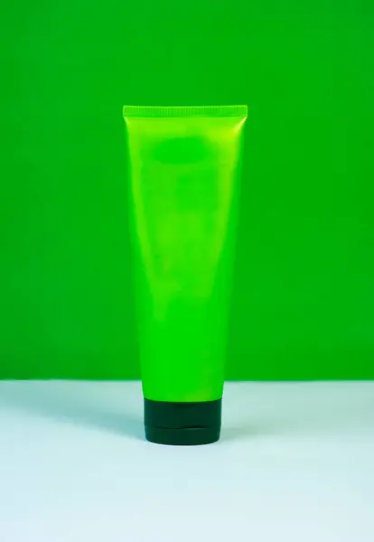 Hand cream tube mockup in green, isolated on a white or green background. Ideal for beauty and skincare product showcases.