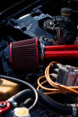 The air filter in a sports car engine, showcasing its contribution to power and efficiency. Great for high-performance vehicle ads and automotive displays. clipart