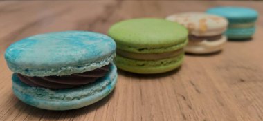 Ahşap arka planda renkli badem kurabiyeleri