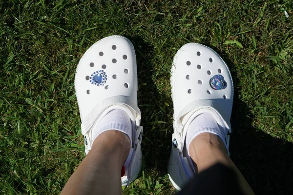 Woman Feet Wearing White Crocs Shoes Legs Grass Royalty Free Stock Images