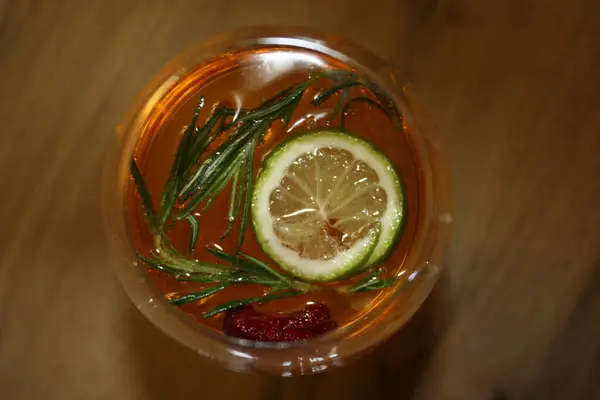 グラスの中のカクテル イエロードリンク ローズマリー レモン バブルで飲む ストック画像