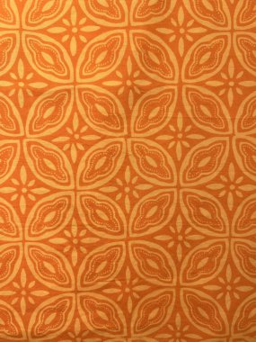 Turuncu arka planda soyut motiflerle geleneksel Endonezya batik kumaşının güzelliğinin dikey fotoğrafı.