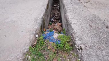 Atık, plastik ve yağlar, insan dikkatsizliğinin çevresel etkilerini ve doğayı koruma aciliyetini gösteren görünür bir kirlilik yaratır..