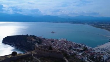 Yunanistan 'ın Nafplio kentinin yukarısındaki antik kaleden bu drone manzarası tarihi liman kenti ve barışçıl Akdeniz' i gösteriyor. Liman, deniz şatosu ve günbatımı manzarayı tamamlıyor..