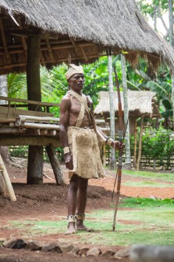 Kopidil, Alor - Indonesia, 21 Nov 2020.A kabola tribe man from the indigenous village of Eneng Hulu wearing traditional kabola clothing made from Ka tree bark holding a bow and arrow.Stock Editorial Photography