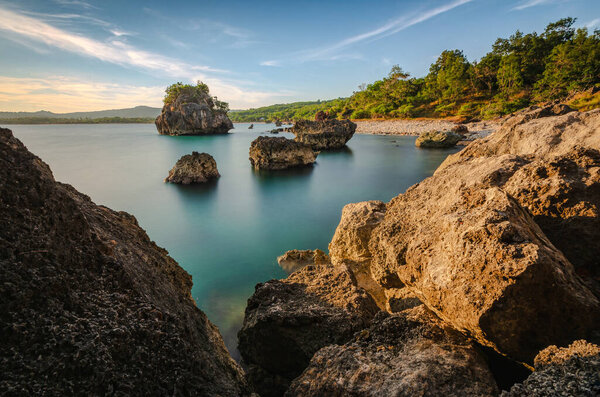  View of the cliffs and boulders on the beach in the afternoon. Oebali beach (Batu Burung Beach), Kupang, East Nusa Tenggara - Indonesia