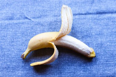 Açık arkaplanda taze sarı muz. Fotokopi alanı olan minimalist yemek fotoğrafçılığı. Sağlıklı beslenme, reklam ve ticari kullanım için ideal.