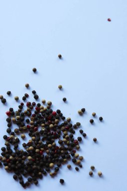 Saf beyaz arka planda siyah biberler izole edilmiş. Minimalist kompozisyon, her bir biberin kendine özgü şekil ve dokusunu vurgular.