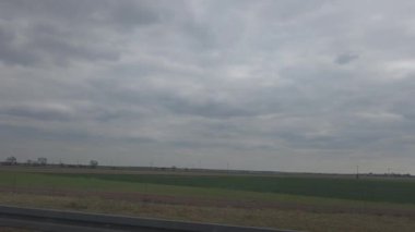 Ormanlarda, tarlalarda ve hareket halindeki bir arabanın camından gökyüzünde manzaralı bir gezinti. Arka planlar, seyahat videoları, reklamlar ve sinema projeleri için mükemmel.