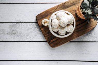 Beautiful and delicious homemade coconut flakes truffles with almonds and nuts in a retro grunge style.