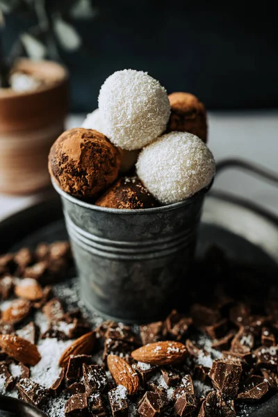 Beautiful and delicious homemade chocolate cocoa dusted and coconut flakes truffles with dark and white chocolate in a retro grunge style.