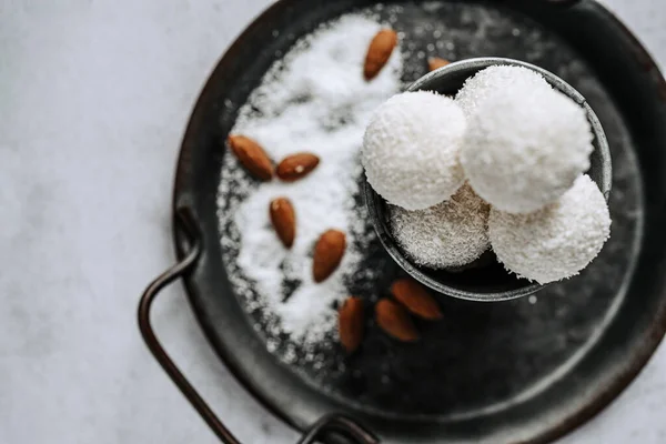 stock image Beautiful and delicious homemade coconut flakes truffles with almonds and nuts in a retro grunge style.