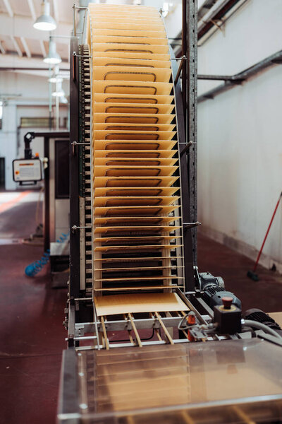 Huge factory line for sweet food and cookies production. Conveyor belt waffle production line.