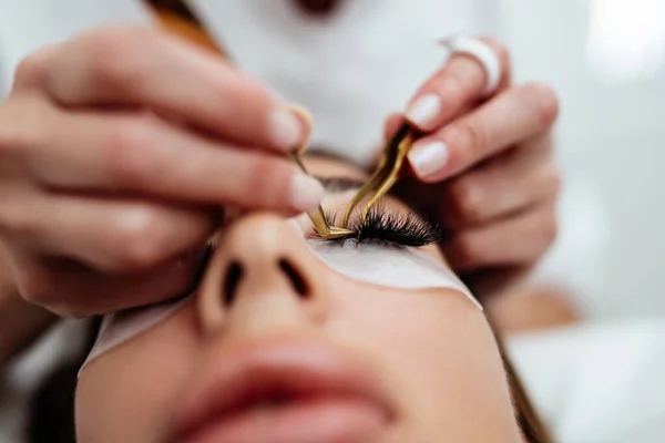 Beautiful Young Adult Woman Receiving Professional Eyelash Makeup Treatment Cosmetician — стоковое фото