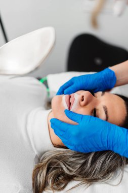 Professional permanent make up procedure. Tattoo lips makeup treatment in modern beauty salon.