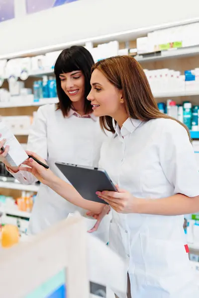 Two Beautiful Pharmacists Working Together Drug Store Doing Stock Take Stock Picture