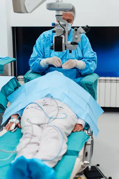 Skilled Surgeon His Medical Team Performs Precise Eye Surgery Elderly ภาพถ่ายสต็อกที่ปลอดค่าลิขสิทธิ์