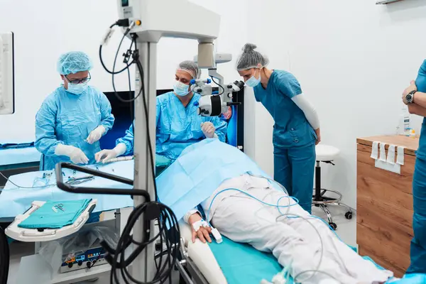 Skilled Surgeon His Medical Team Performs Precise Eye Surgery Elderly Стоковая Картинка