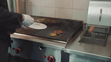 Yakışıklı sakallı profesyonel şef restoran mutfağında çalışıyor. O, balık ve deniz ürünleriyle sağlıklı lezzetli yemekler hazırlar..