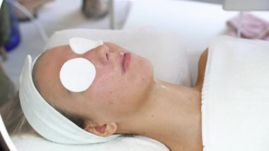 Genç bir kadın termal ozon yüz buharı ile güzellik tedavisi görüyor. Profesyonel kozmetoloji salonu veya güzellik merkezi prosedürü.