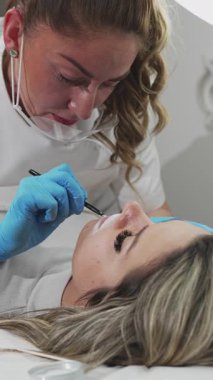 Profesyonel kalıcı makyaj prosedürü. Modern güzellik salonunda dövmeli dudak makyajı.